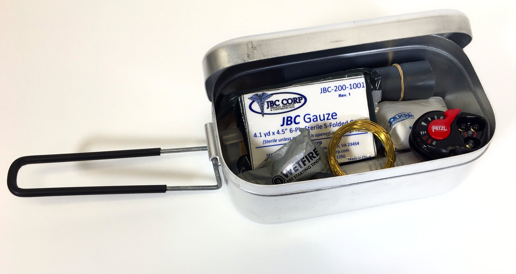 Aluminum Mess Tin with tight fitting lid and foldable handle. This picture shows that you can also use this tin to store items.