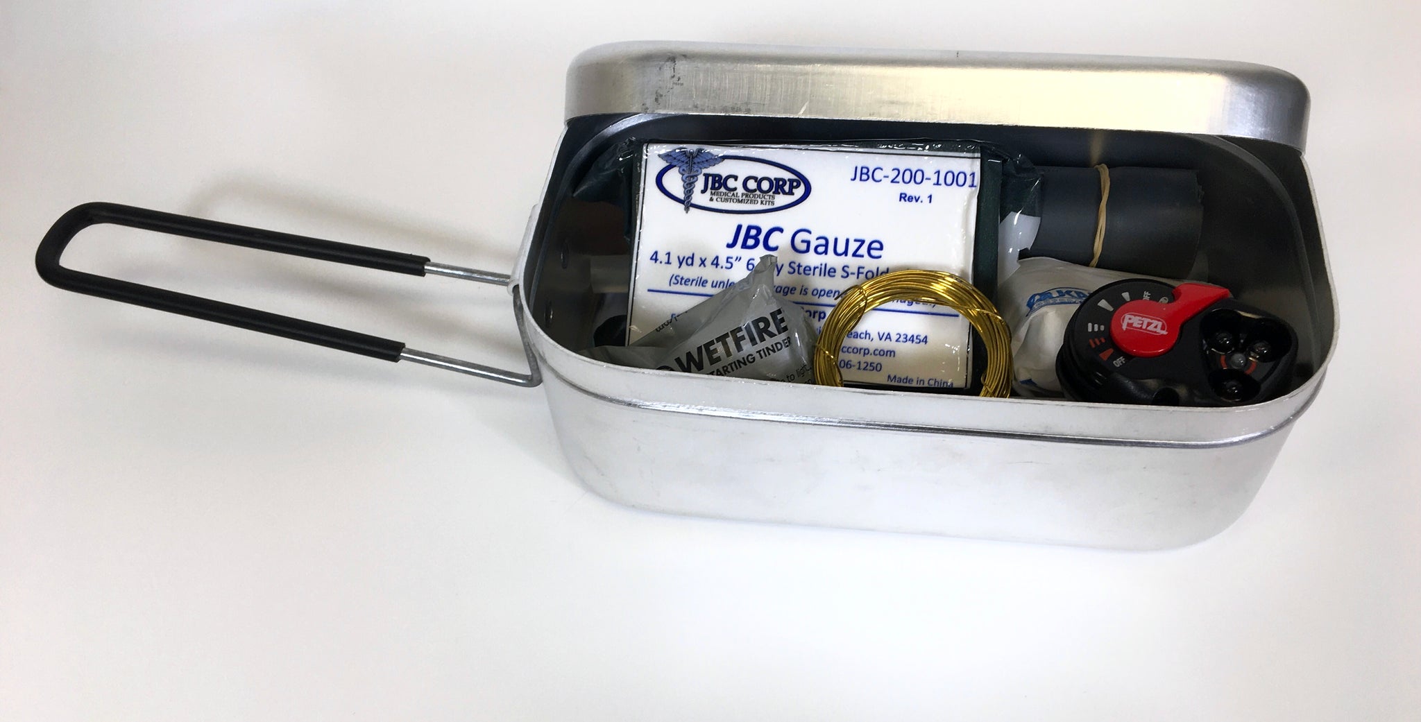 Aluminum Mess Tin with tight fitting lid and foldable handle. This picture shows that you can also use this tin to store items.