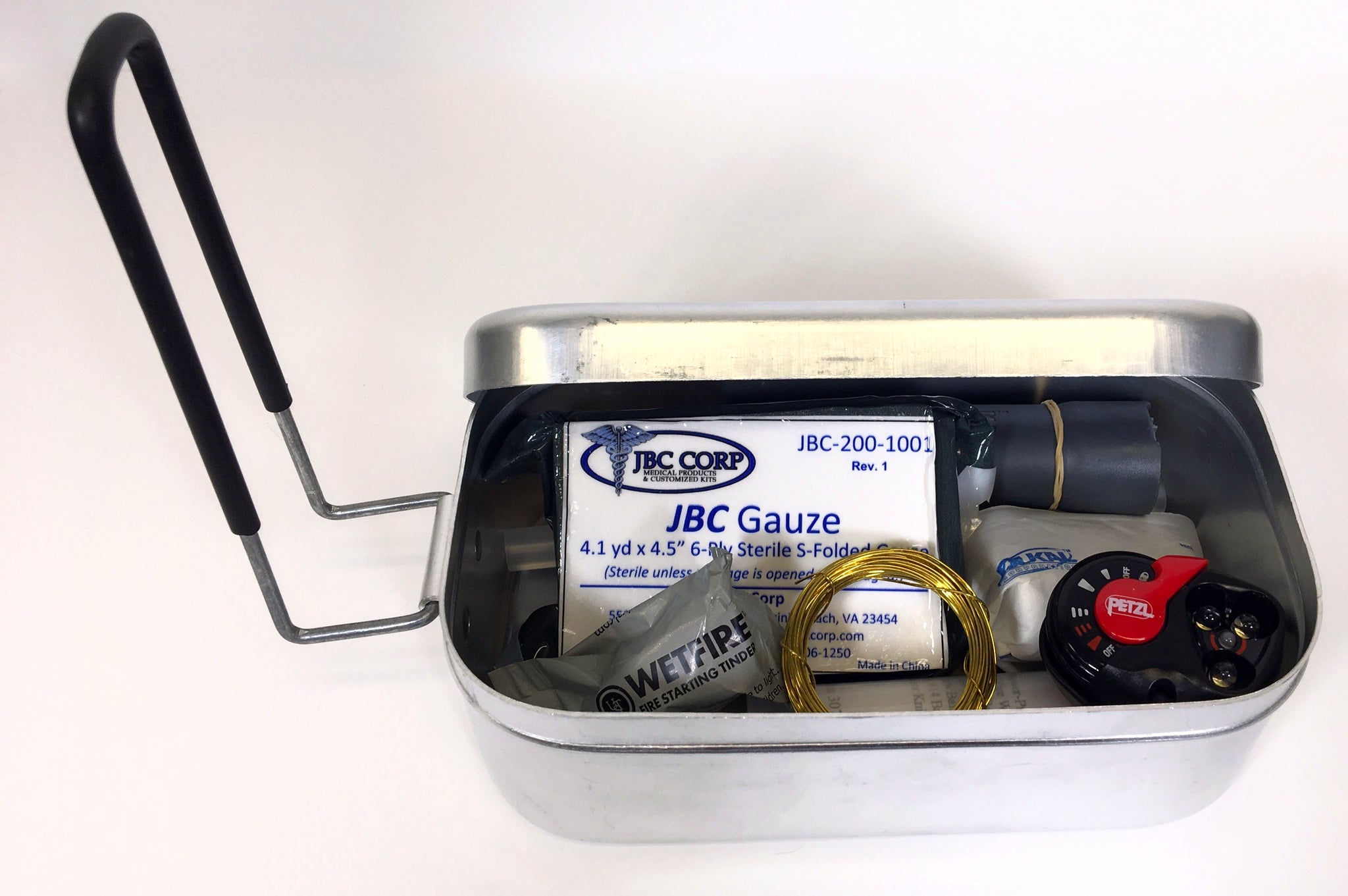 Aluminum Mess Tin with tight fitting lid and foldable handle. This picture shows that you can also use this tin to store items.