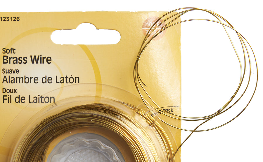 Packaged soft brass wire with clear plastic cover on yellow background