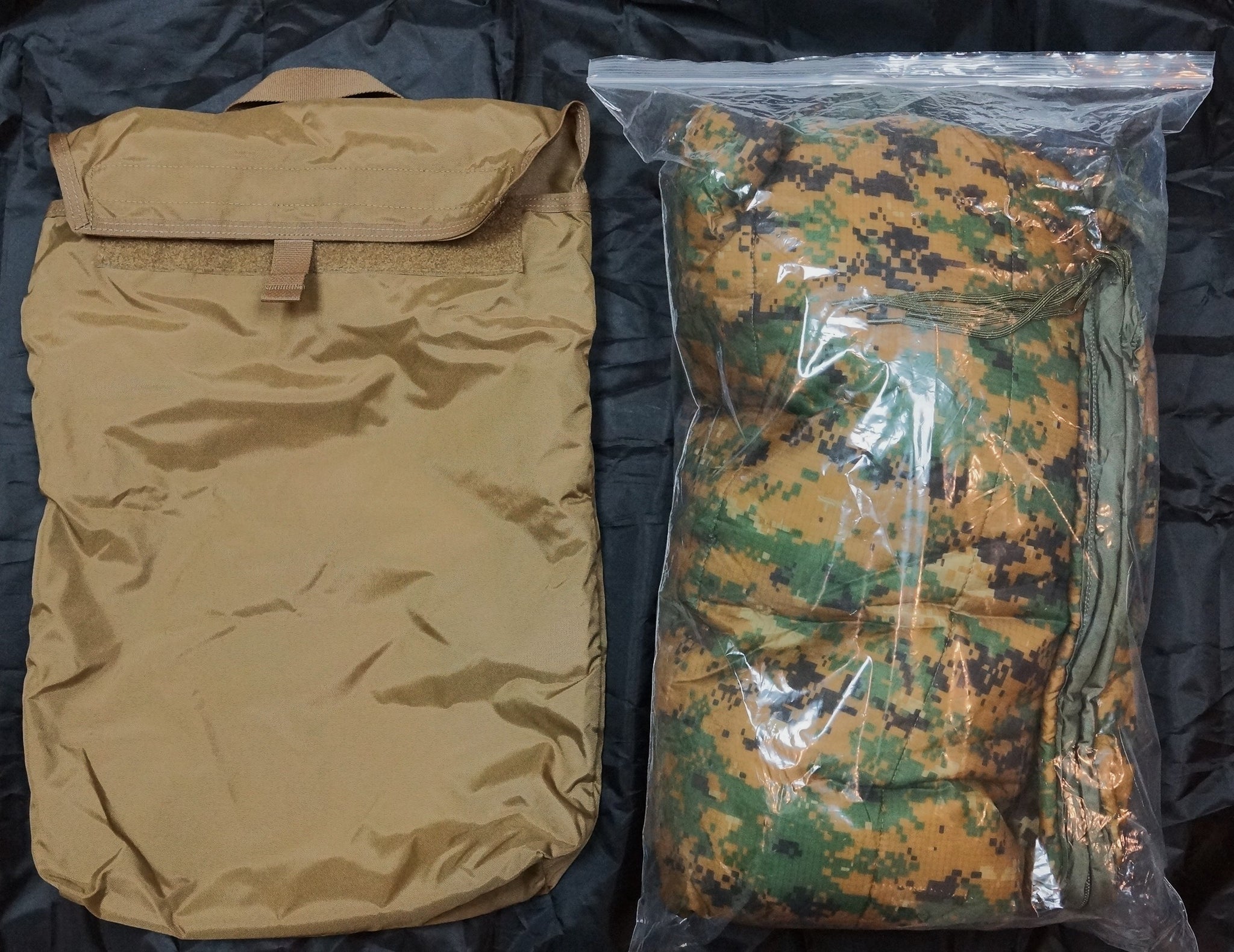 A tan nylon bag with a flap closure is shown next to a clear plastic bag containing a matching camouflage-patterned poncho liner, both laid flat on a black background.