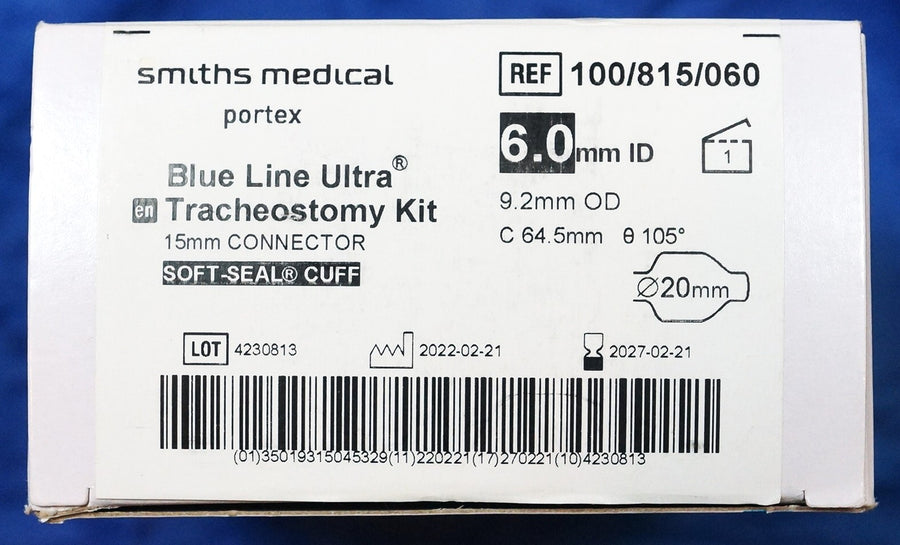 Smiths Medical Portex Blue Line Ultra Tracheostomy Tube Kits shown with its contents on a blue background, including a plastic-wrapped white tube, a clear plastic tray with tubes and accessories, and an instruction booklet.