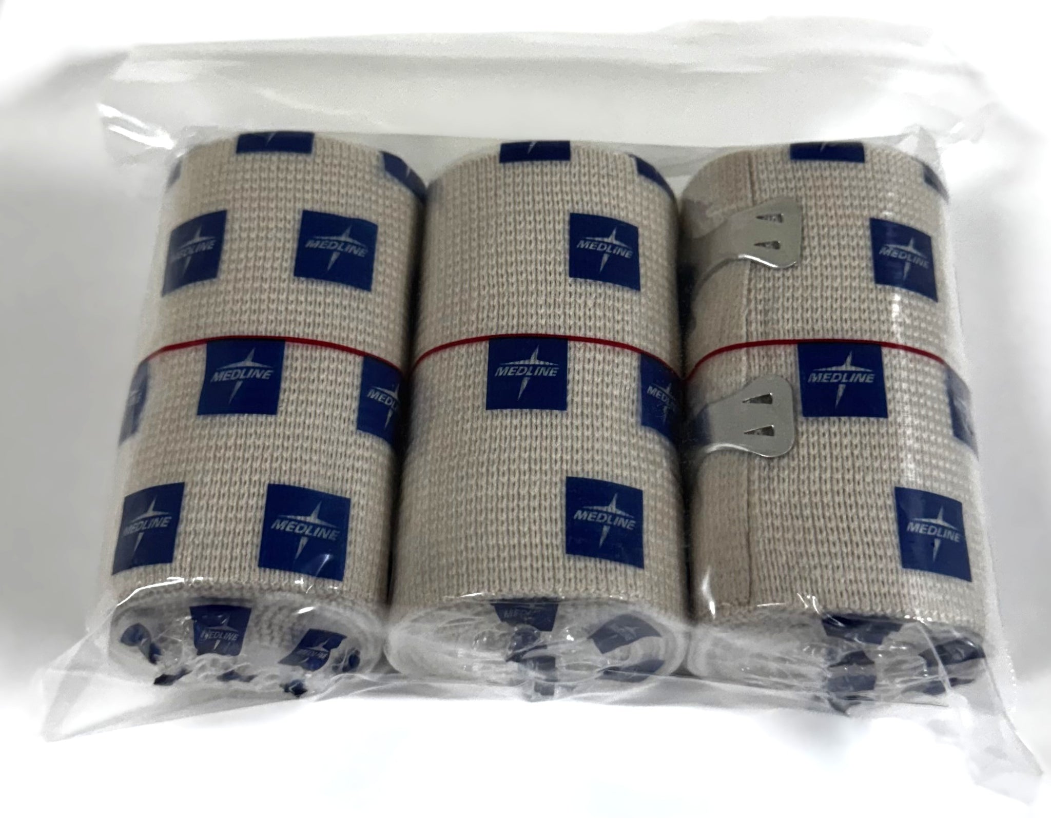 Three rolls of beige woven medical bandage tape with blue Medline logos, packaged in a clear plastic bag on a white background.