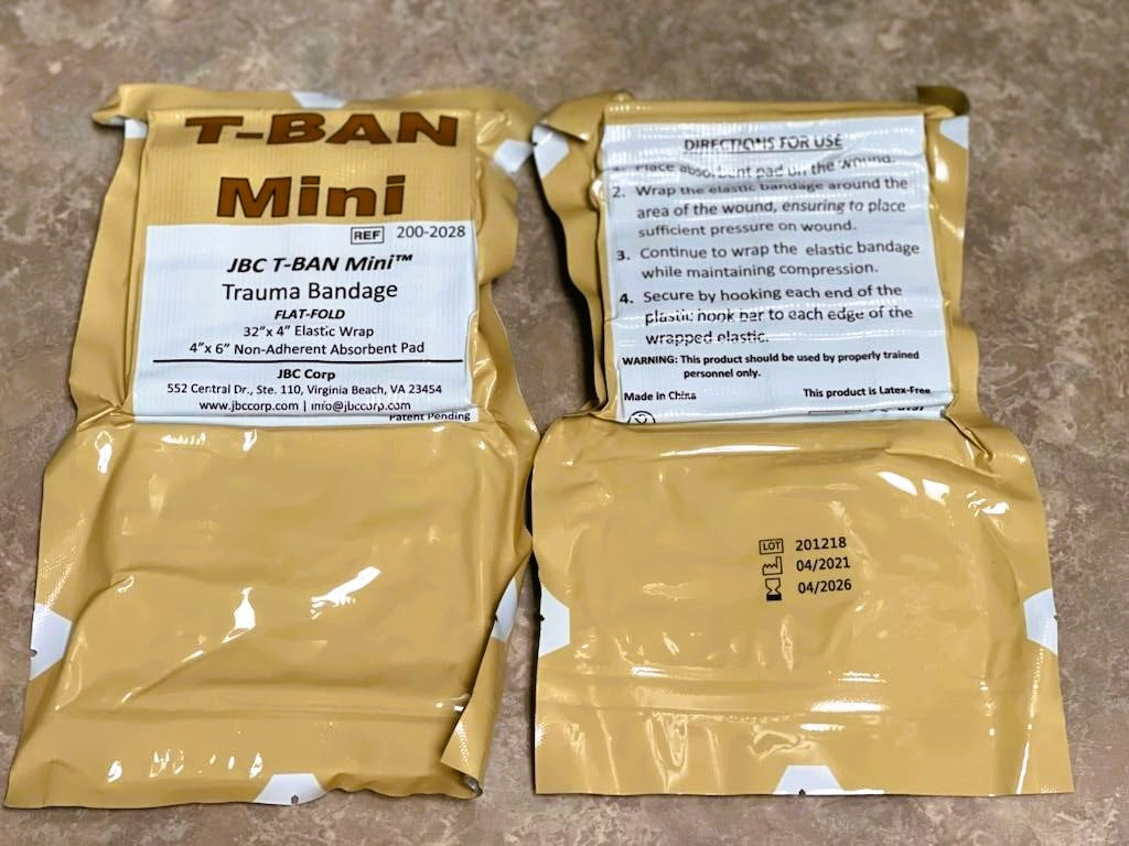 Front and backside of JBC T-Ban Mini Trauma Bandage packaging.